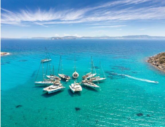 Sailing boats in star formation in Greece (Polyaigos, Cyclades) the largest uninhabited island of the Aegean Sea and one of the best and most beautiful sailing destinations