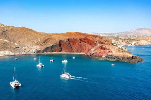 Catamarans anchored at Santorini Red Beach