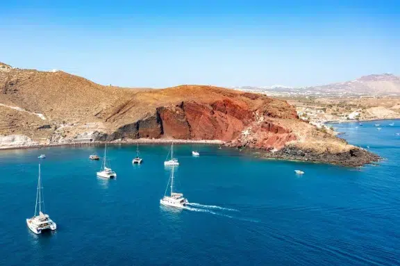 Catamarans anchored at Santorini Red Beach