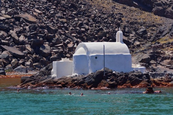 There is a number of hot springs sprinkled around the volcanic Nea Kameni. Your captain will know the less visited ones.