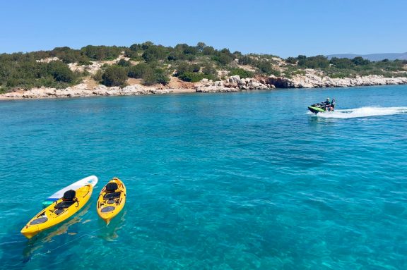 Guests from motor yacht ANKA trying out the jet ski in the calm clear waters of Korakia Island, Greece