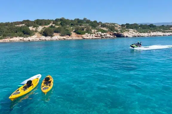 Guests from motor yacht ANKA trying out the jet ski in the calm clear waters of Korakia Island, Greece