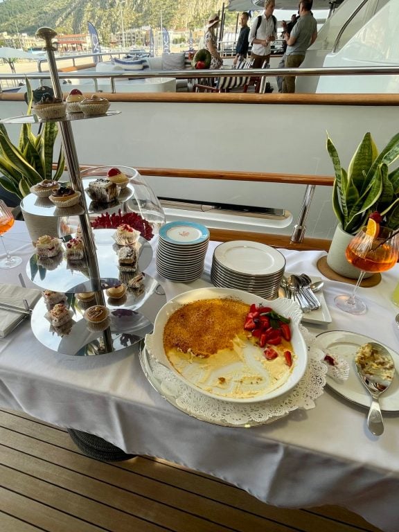 Motor Yacht Bella Stella’s dessert station—housemade cupcakes and a rich crème brûlée with fresh strawberries, served on deck as the sun went down.