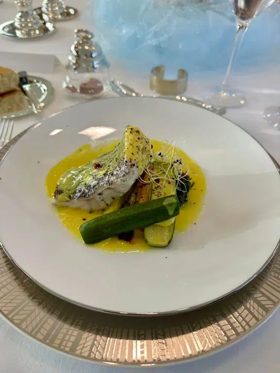 M/Y HAKUNA MATATA serves Golden Grouper "frikase" with lemon sauce, served with baby zucchini and root vegetables. Understated plating, maximum flavor.
