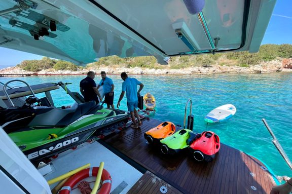 crew launching water toys off the beach deck of motor yacht ANKA at Korakia Island, Greece