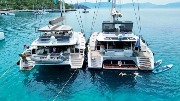 2 catamarans rafted up to each other on anchor for Tandem charter