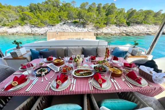 Motor yacht ANKA serves traditional greek meze lunch anchored off Agistri Island, Greece