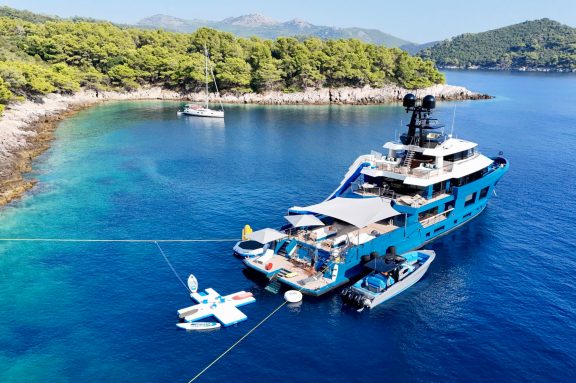 Superyacht KING BENJI anchored with stern lines to the rocky shore