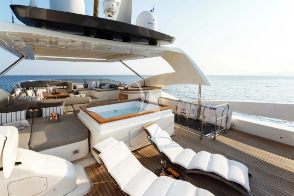 The exceptionally spacious Fly Bridge has a large Jacuzzi, hard top with electrically retractable canvas roof, a bar, a large foldable dining table, lounges & sunbathing areas