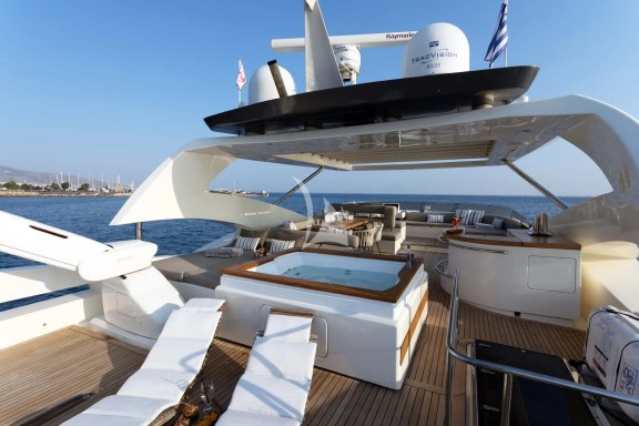The exceptionally spacious Fly Bridge has a large Jacuzzi, hard top with electrically retractable canvas roof, a bar, a large foldable dining table, lounges & sunbathing areas