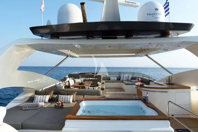 The exceptionally spacious Fly Bridge has a large Jacuzzi, hard top with electrically retractable canvas roof, a bar, a large foldable dining table, lounges & sunbathing areas