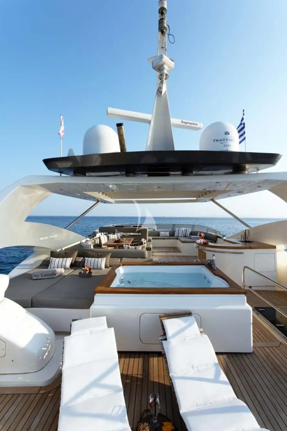 The exceptionally spacious Fly Bridge has a large Jacuzzi, hard top with electrically retractable canvas roof, a bar, a large foldable dining table, lounges & sunbathing areas