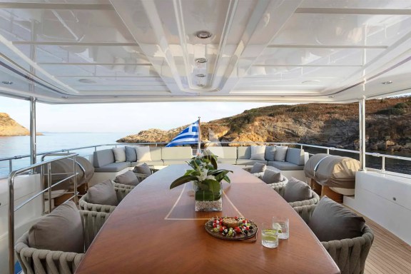The Upper Deck veranda has a large dining table, a bar and a large sofa
