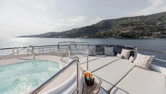 Large sunbathing area next to jacuzzi