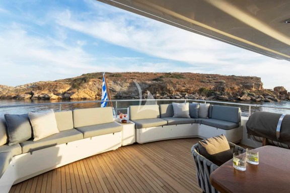 The Upper Deck veranda has a large dining table, a bar and a large sofa