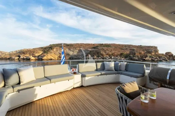 The Upper Deck veranda has a large dining table, a bar and a large sofa