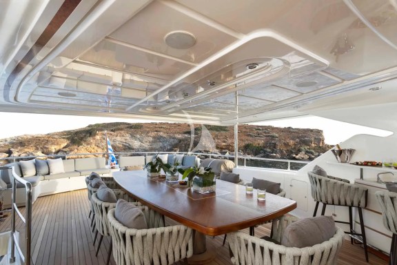 The Upper Deck veranda has a large dining table, a bar and a large sofa