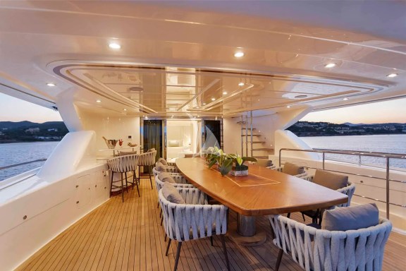 The Upper Deck veranda has a large dining table, a bar and a large sofa