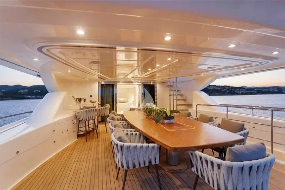 The Upper Deck veranda has a large dining table, a bar and a large sofa