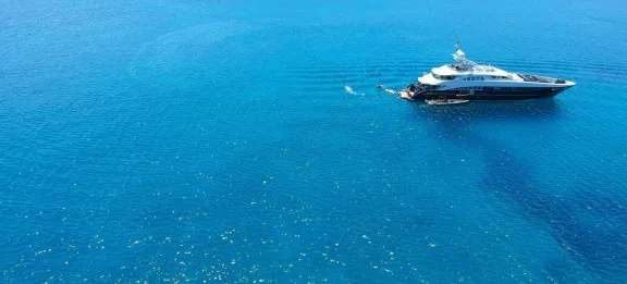 Superyacht anchored off a Cycladic island on a Greece yacht charter